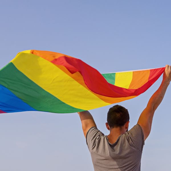 man with LGBT flag